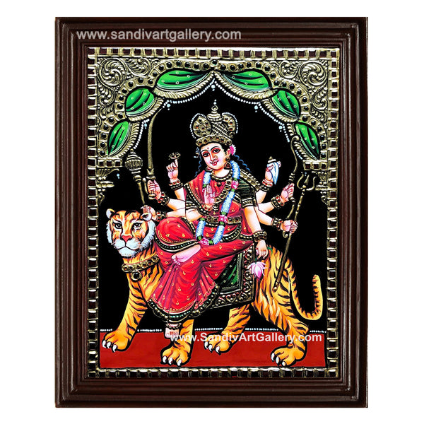 Traditional Tanjore painting of the Hindu goddess Durga, featuring real 22-karat gold foil embossing and vibrant colors within a teakwood frame.